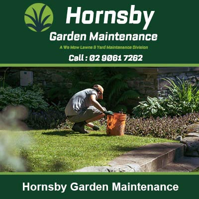 Gardener kneeling and working in a flower bed in Hornsby