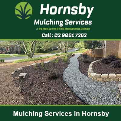 Curved garden bed with dark mulch spread around in Hornsby