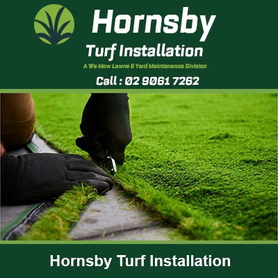 Person in work boots laying fresh turf in Hornsby